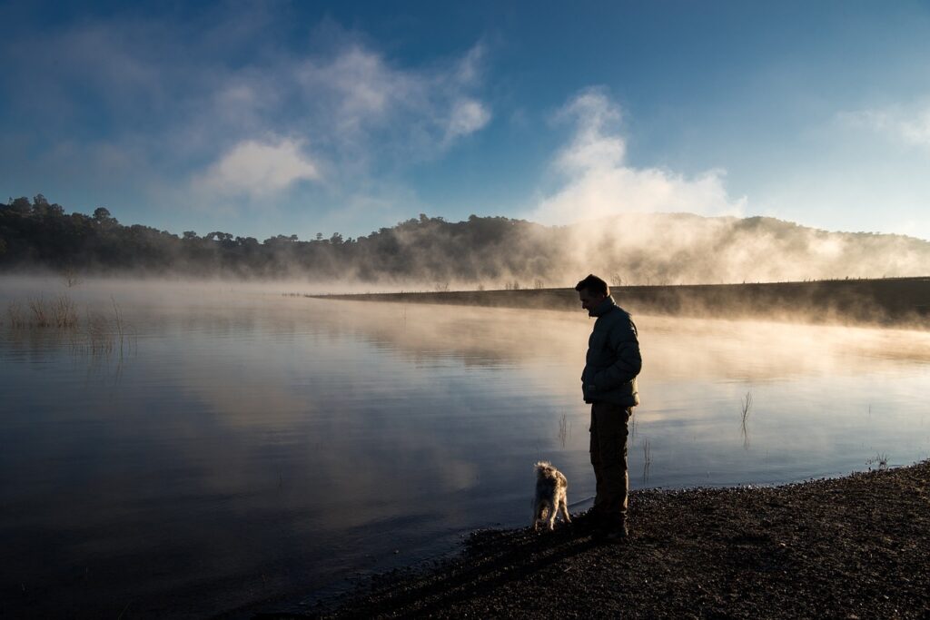 Man with dog at lake